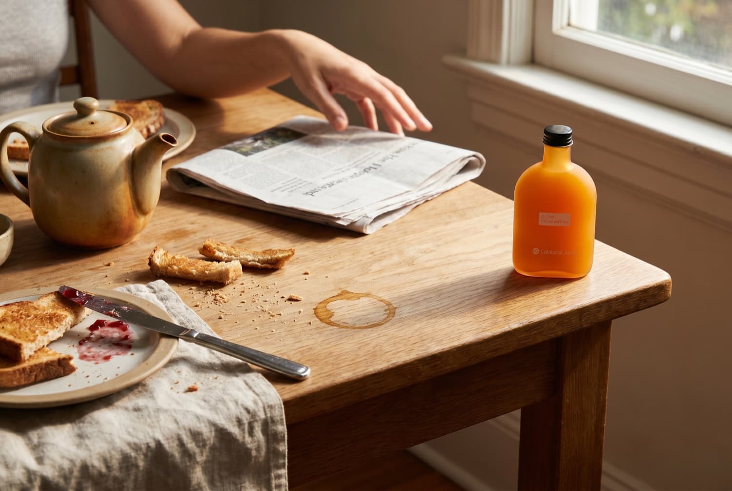 An unhurried breakfast table with a Lalaland bottle at the corner