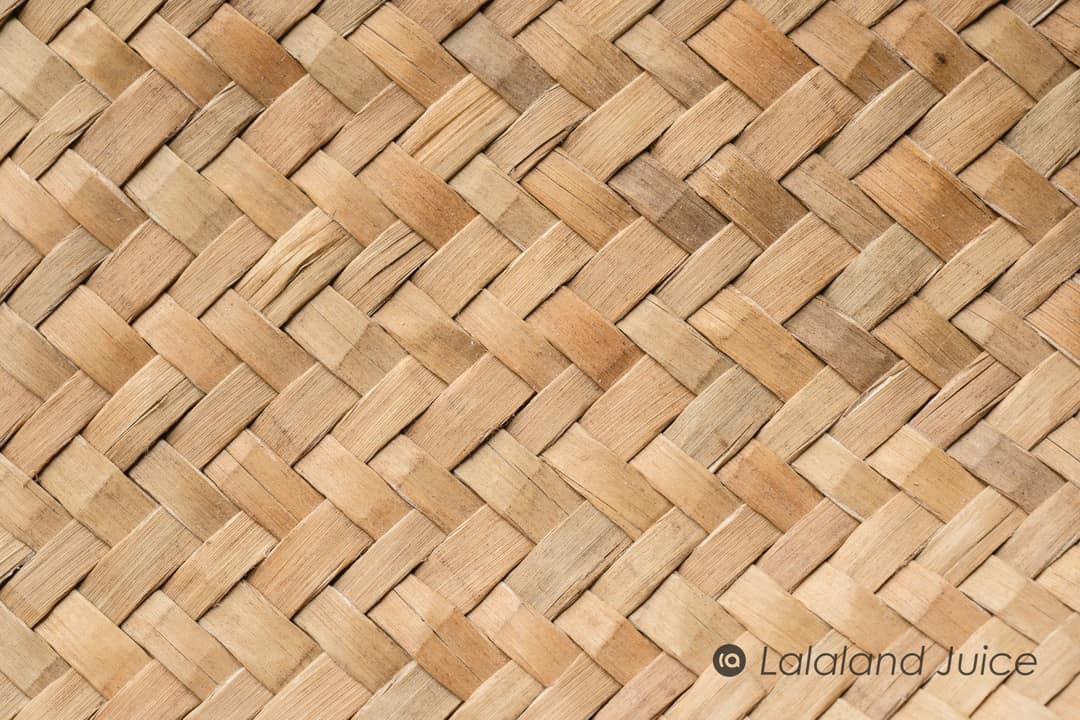 A rattan weave in warm afternoon light — the texture of an hour spent horizontal.
