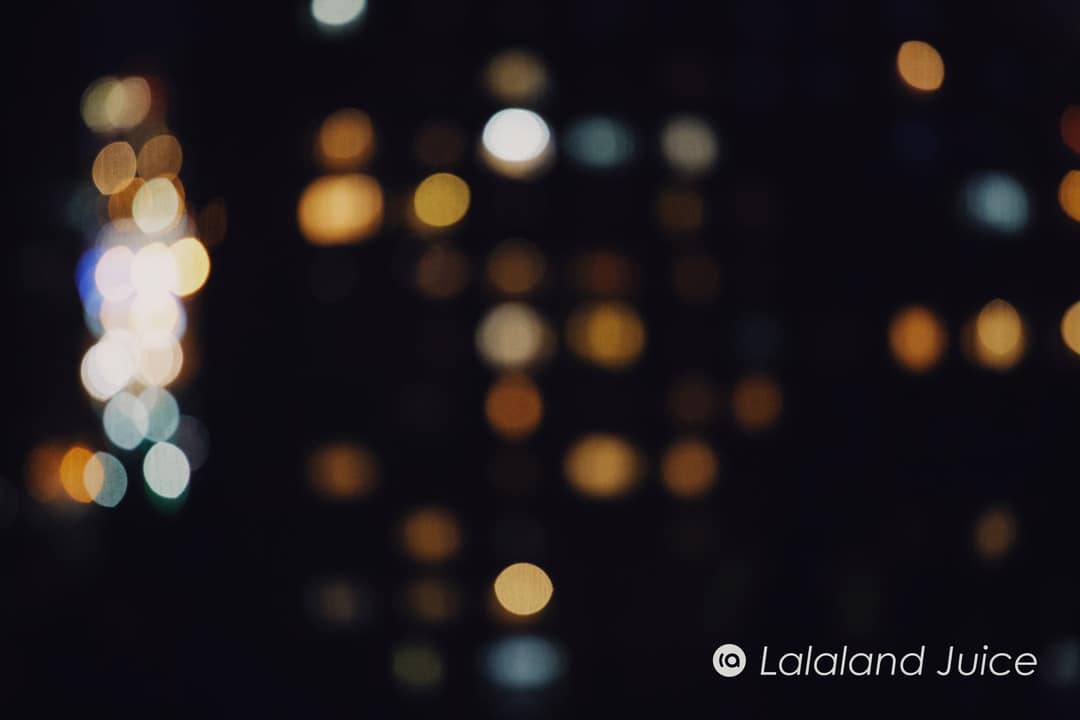 The city at night, softened to a warm glow.