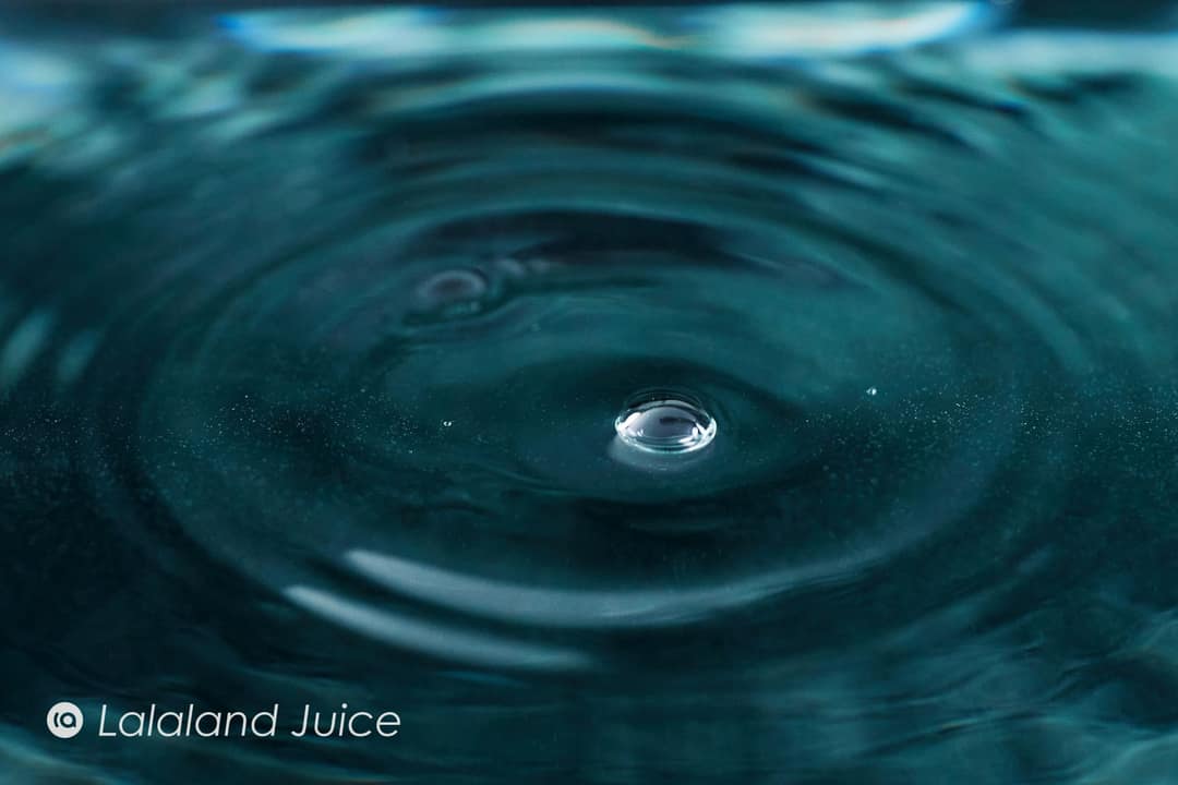 A single drop settling on still water.