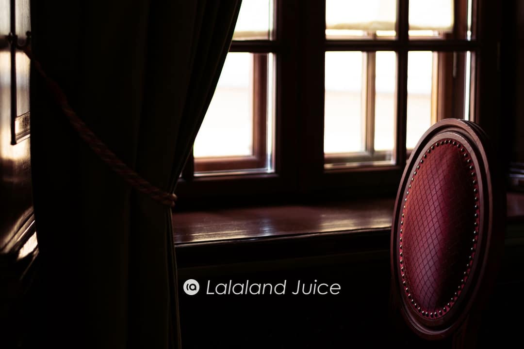 A quiet corner by a window in the late afternoon, an empty chair turned toward the light.